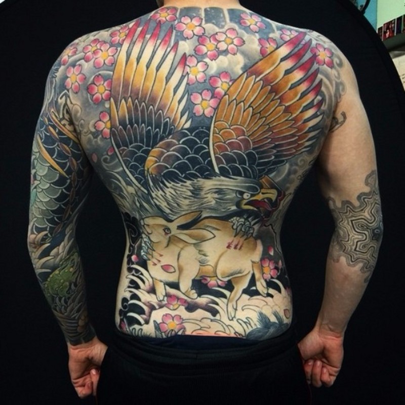 Asian style multicolored whole back tattoo of eagle with rabbit and flowers