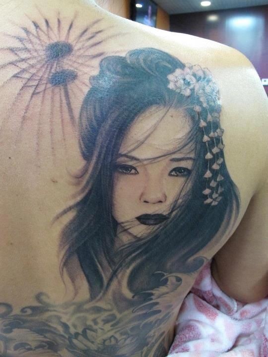 Asian style very detailed sad geisha with flowers tattoo on shoulder