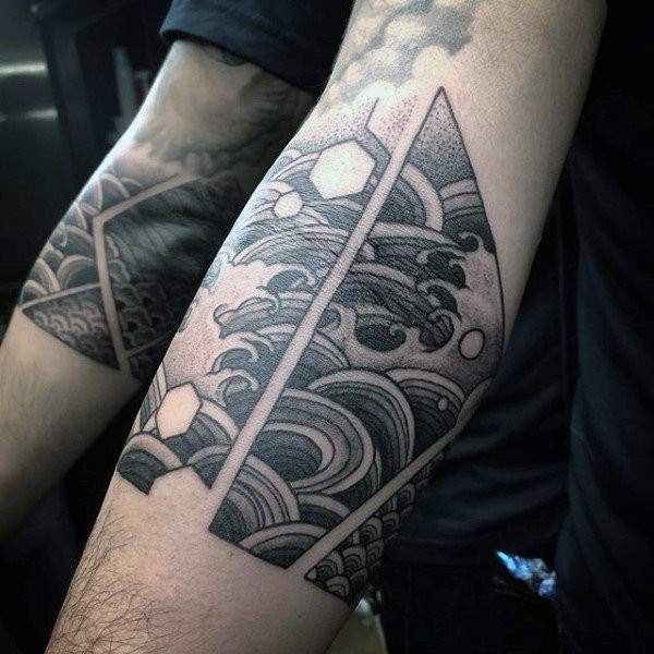 Asian traditional style arm tattoo of waves combined with geometrical figures