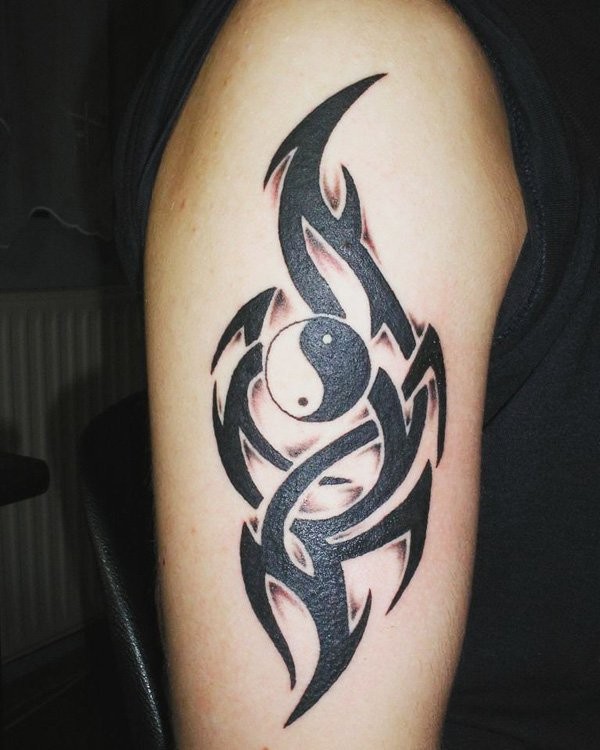 Asian Yin Yang special symbol with dark black tribal style elements tattoo on shoulder