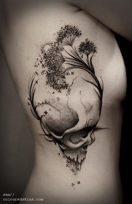 Awesome 3D style black ink human skull tattoo on side combined with wildflowers