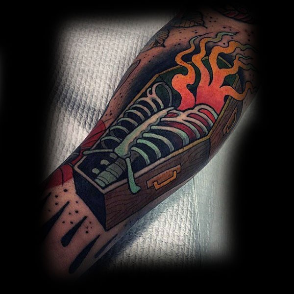 Awesome big colored coffin with burning skeleton tattoo on arm