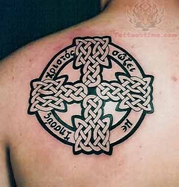Awesome celtic irish cross tattoo on shoulder blade