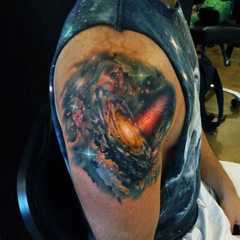 Awesome colored little space tattoo on upper arm