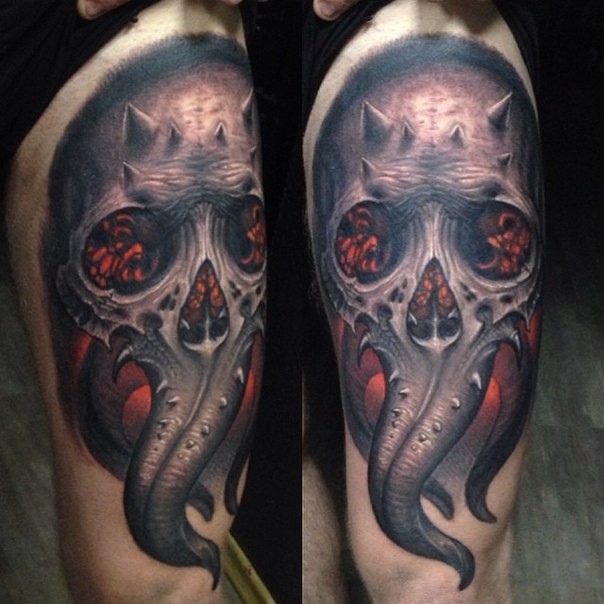 Awesome colored thigh tattoo of demonic skull with flames