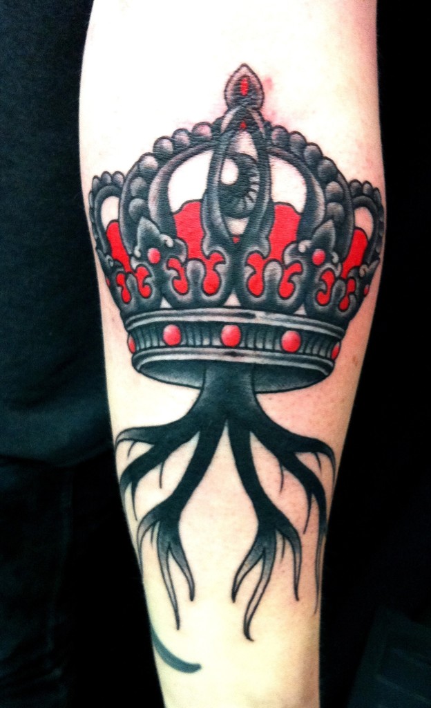 Awesome crown black and red colored tattoo