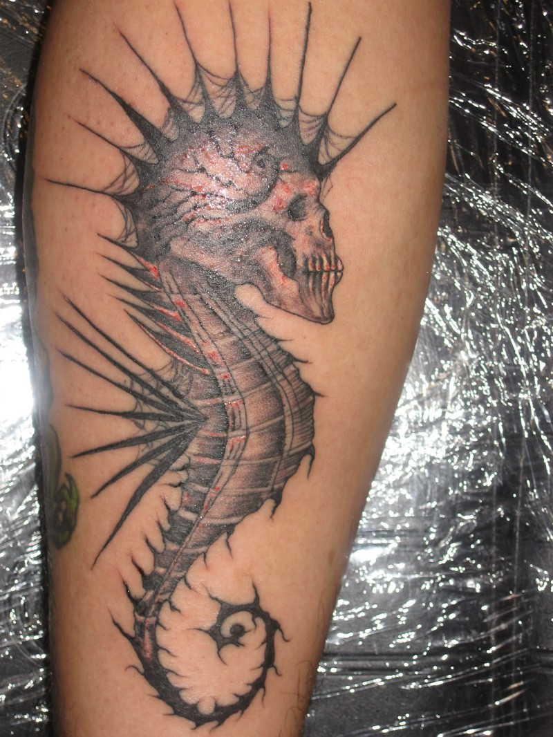 Awesome designed and painted little seahorse with skull tattoo on leg