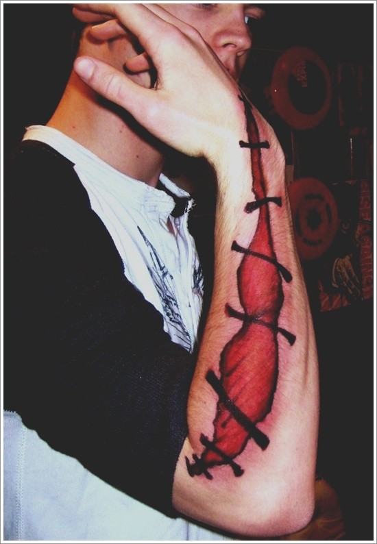 Awesome designed big sutured scar tattoo on arm