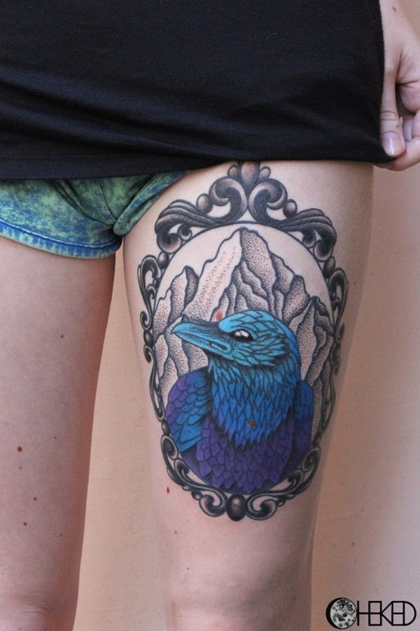 Awesome designed big thigh tattoo of interesting colored bird portrait