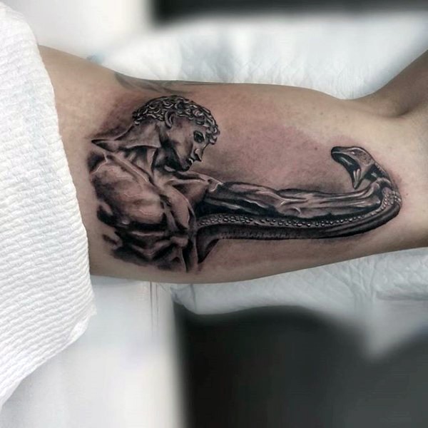 Awesome designed black and white antic man with snake statue tattoo on biceps