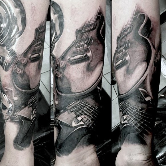 Awesome designed black and white various guitars tattoo on arm