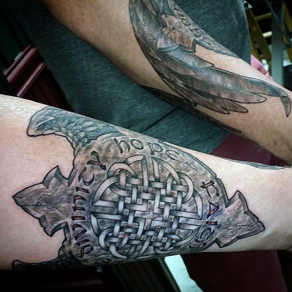 Awesome designed detailed Celtic shield with lettering tattoo on arm