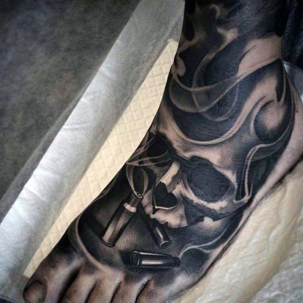 Awesome designed lack ink skull with bullets tattoo on foot