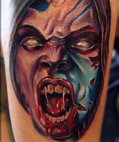 Awesome detailed and colored bloody evil monster face tattoo on arm