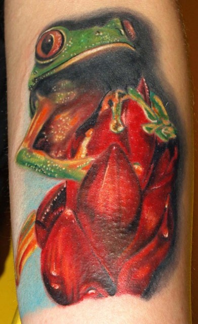 Awesome frog with red flowers tattoo