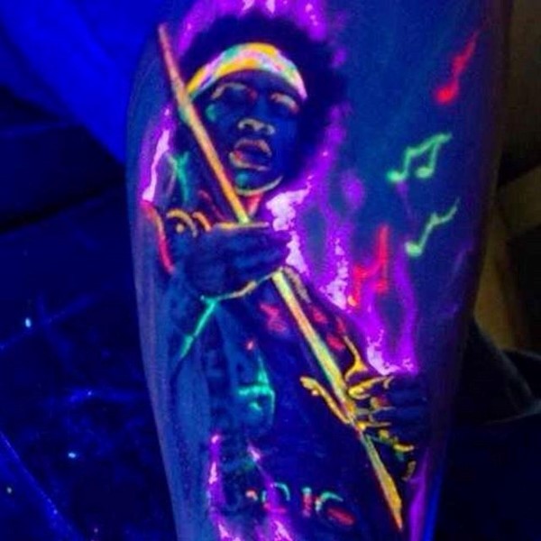 Awesome glowing ink colored musician tattoo on leg