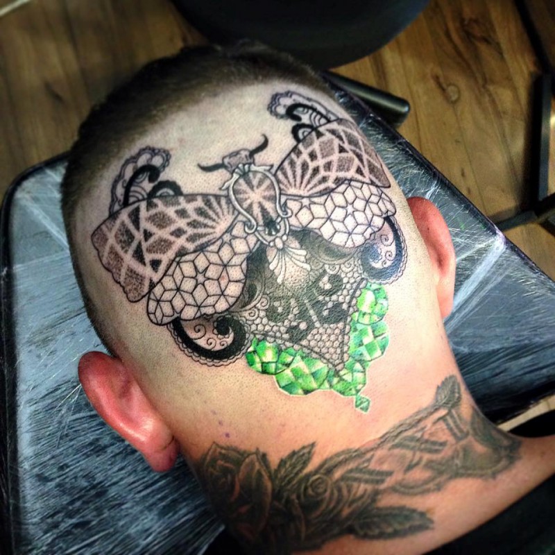 Awesome looking colored head tattoo of big butterfly with diamonds