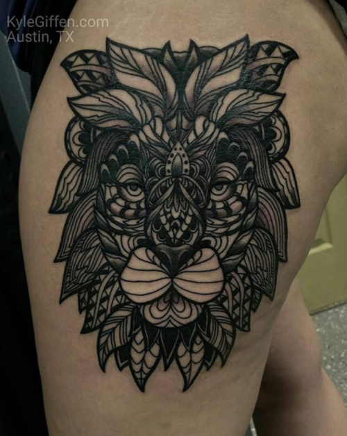 Awesome looking colored thigh tattoo of lion head stylized with beautiful ornaments