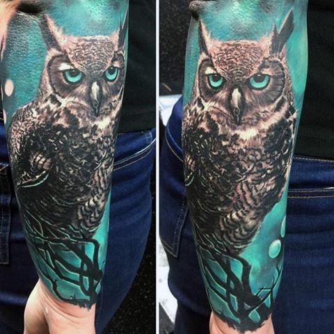 Awesome multicolored big mystic owl tattoo on sleeve