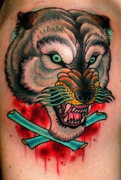 Awesome multicolored evil beast tattoo on shoulder combined with crossed bones