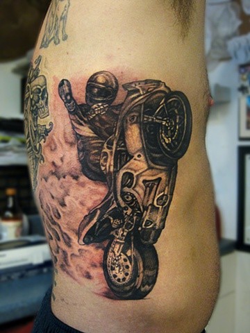 Awesome racer in sports bike tattoo on ribs