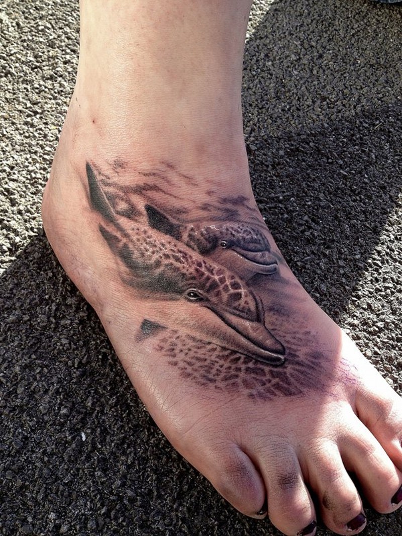 Awesome realistic black ink dolphins tattoo on foot