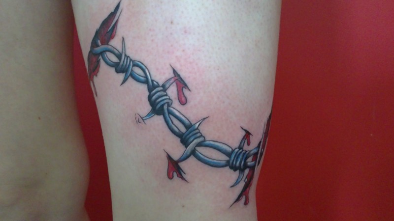 Awesome ripped skin barbed wire tattoo