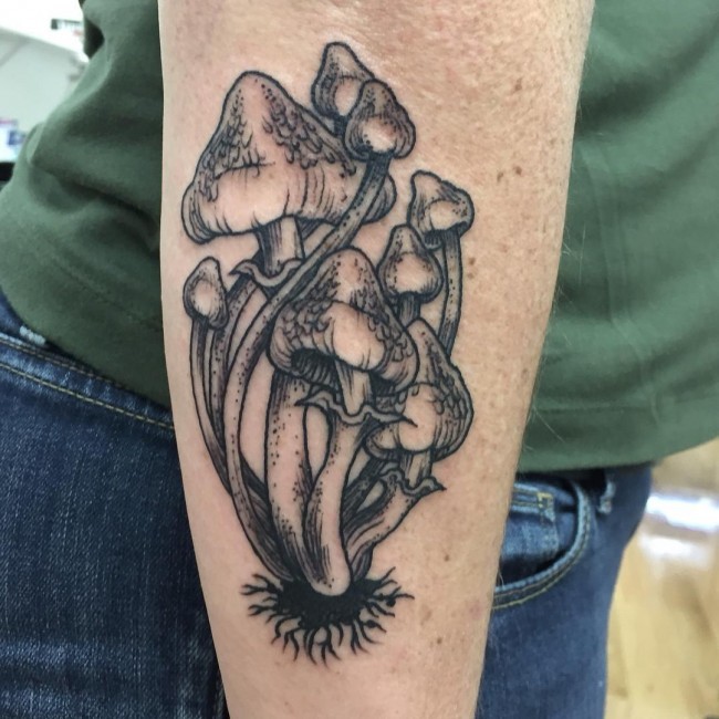 Awesome very detailed black ink mushrooms tattoo on forearm