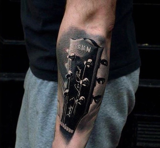 Awesome very detailed named guitar tattoo on arm