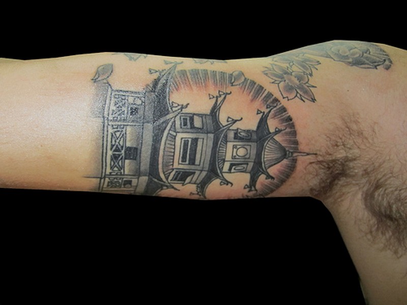 Beautiful accurate painted colored Asian house tattoo on biceps