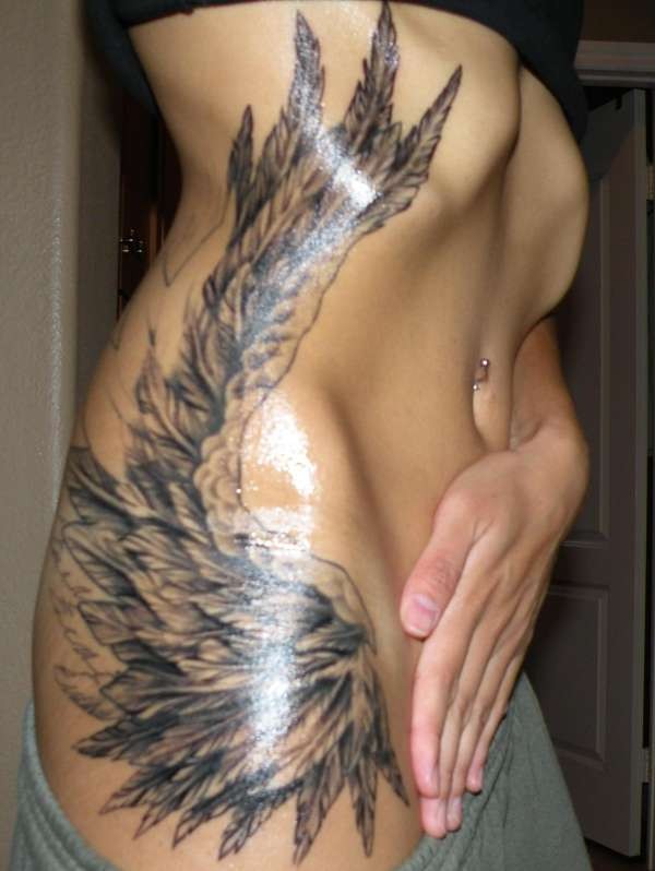 Beautiful angel wing tattoo on ribs for girls