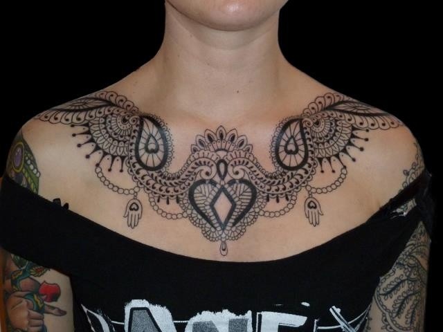 Beautiful black lace chest tattoo by Saira Hunjan