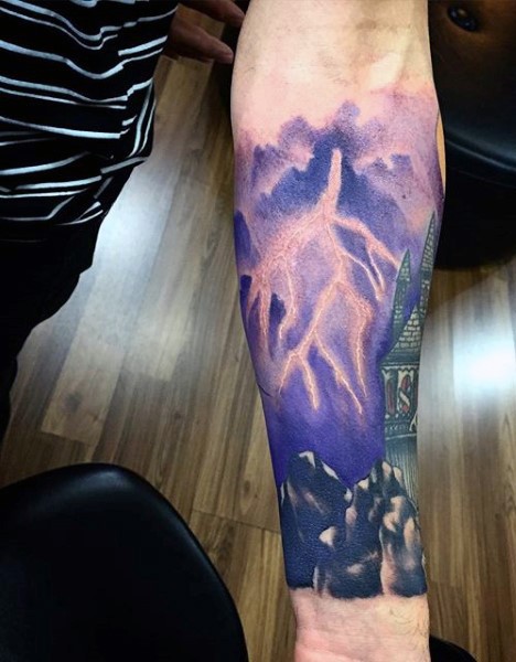 Beautiful colored little lightning with castle tattoo on arm