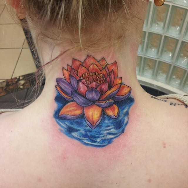 Beautiful colored little lotus flower tattoo on neck