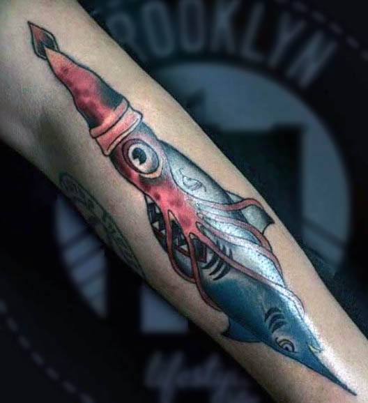 Beautiful colored little squid with sharks tattoo on arm