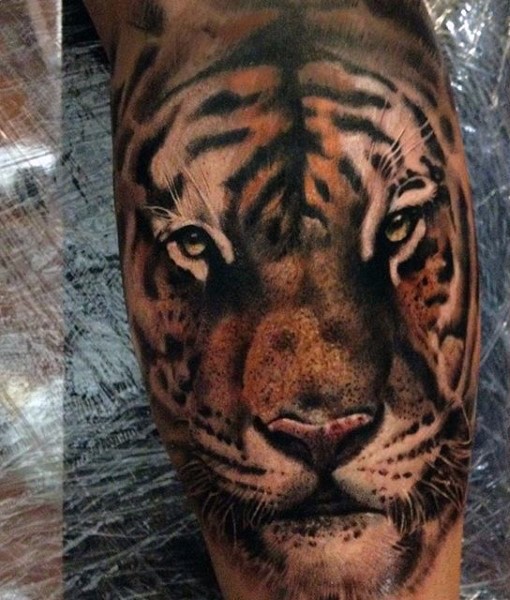 Beautiful colored tiger head tattoo on leg