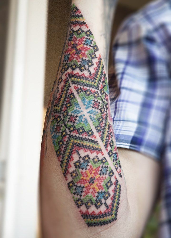 Beautiful colorful cross stitch forearm tattoo