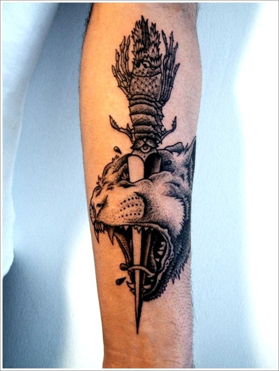 Beautiful dagger pierced head of tiger forearm tattoo