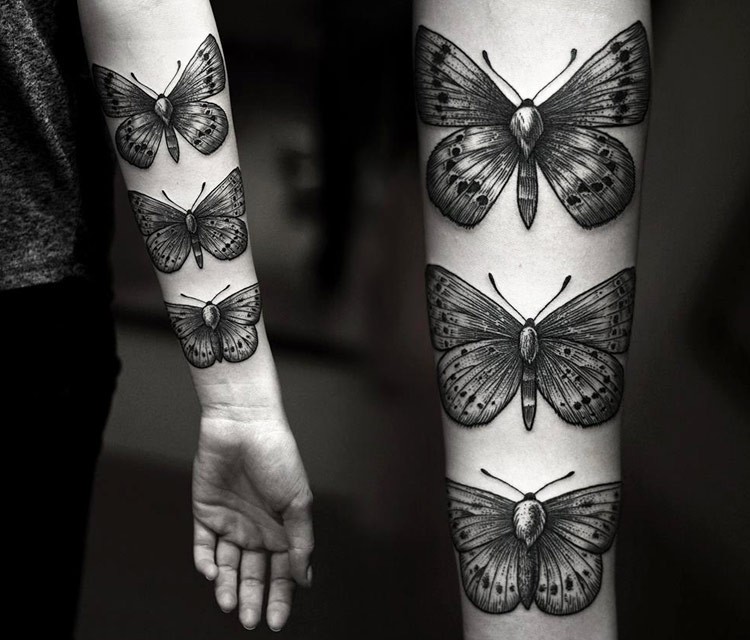 Beautiful engraving style forearm tattoo of various batterflies