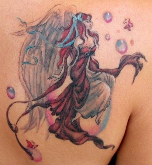 Beautiful fairy tattoo in color on shoulder blade