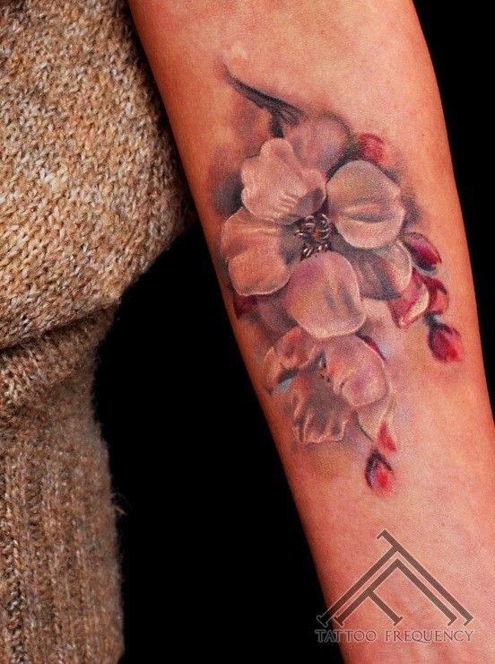 Beautiful illustrative style colored forearm tattoo of big flower