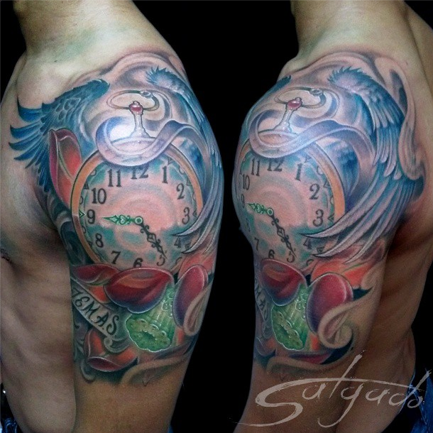 Beautiful illustrative style colored shoulder tattoo of big clock with wings and lettering