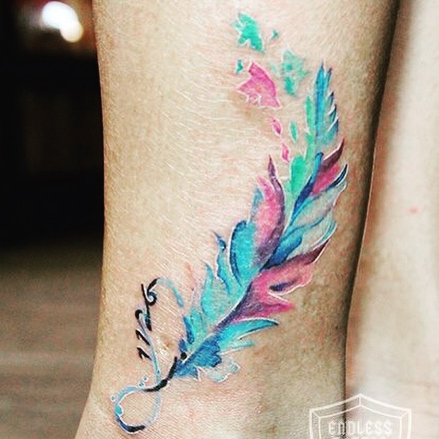 Beautiful illustrative style leg tattoo of feather - Tattooimages.biz