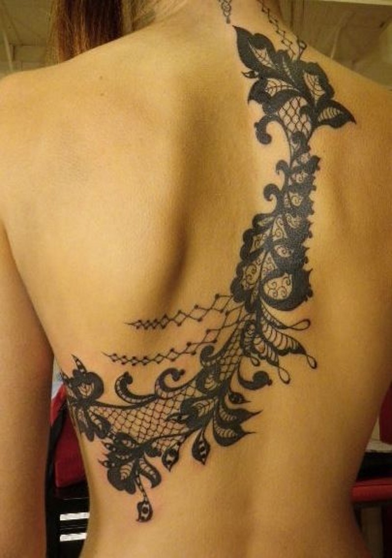 Beautiful lace like black ink flowers tattoo on back