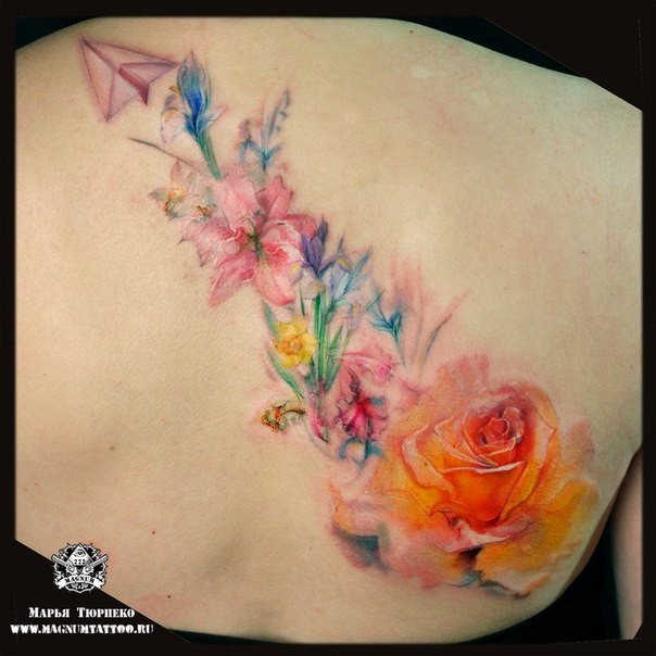Beautiful looking colored back tattoo of flowers and paper plane