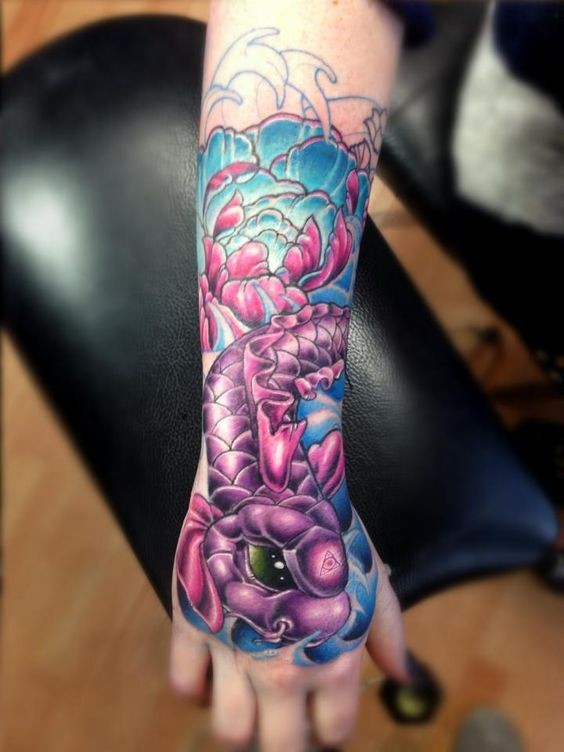 Beautiful looking colored hand tattoo of fantasy fish with flowers
