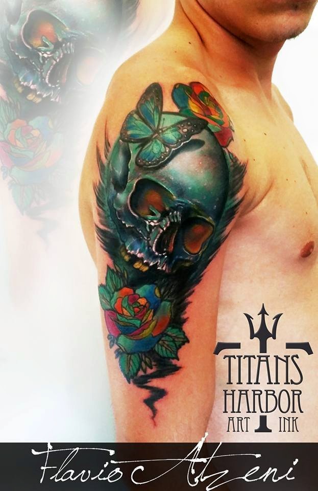 Beautiful looking colored shoulder tattoo of human skull with flowers and butterfly