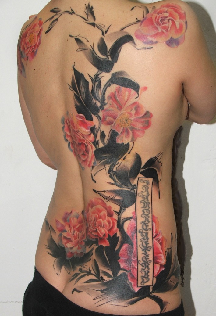 Beautiful looking colored whole back tattoo of beautiful flowers with lettering