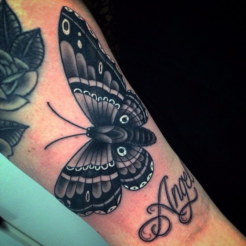 Beautiful looking leg tattoo of big butterfly with lettering
