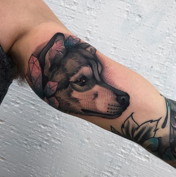 Beautiful modern style biceps tattoo of cute wolf with crystals